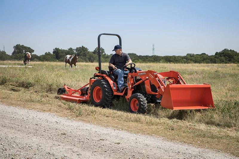 man mowing lawn with rear implement