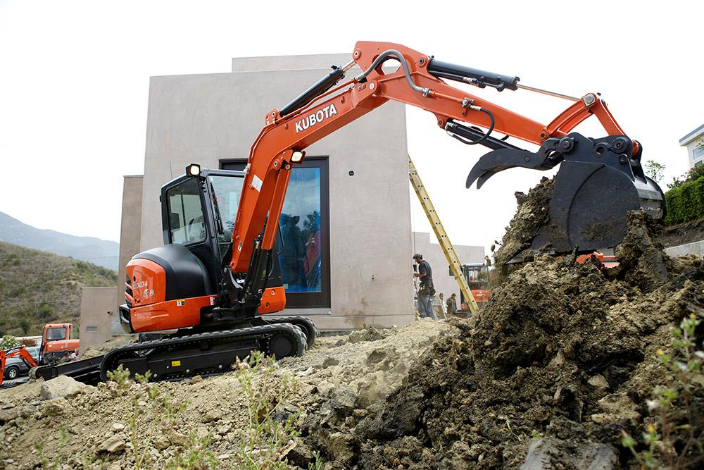 Compact Excavator digging on a residential construction area