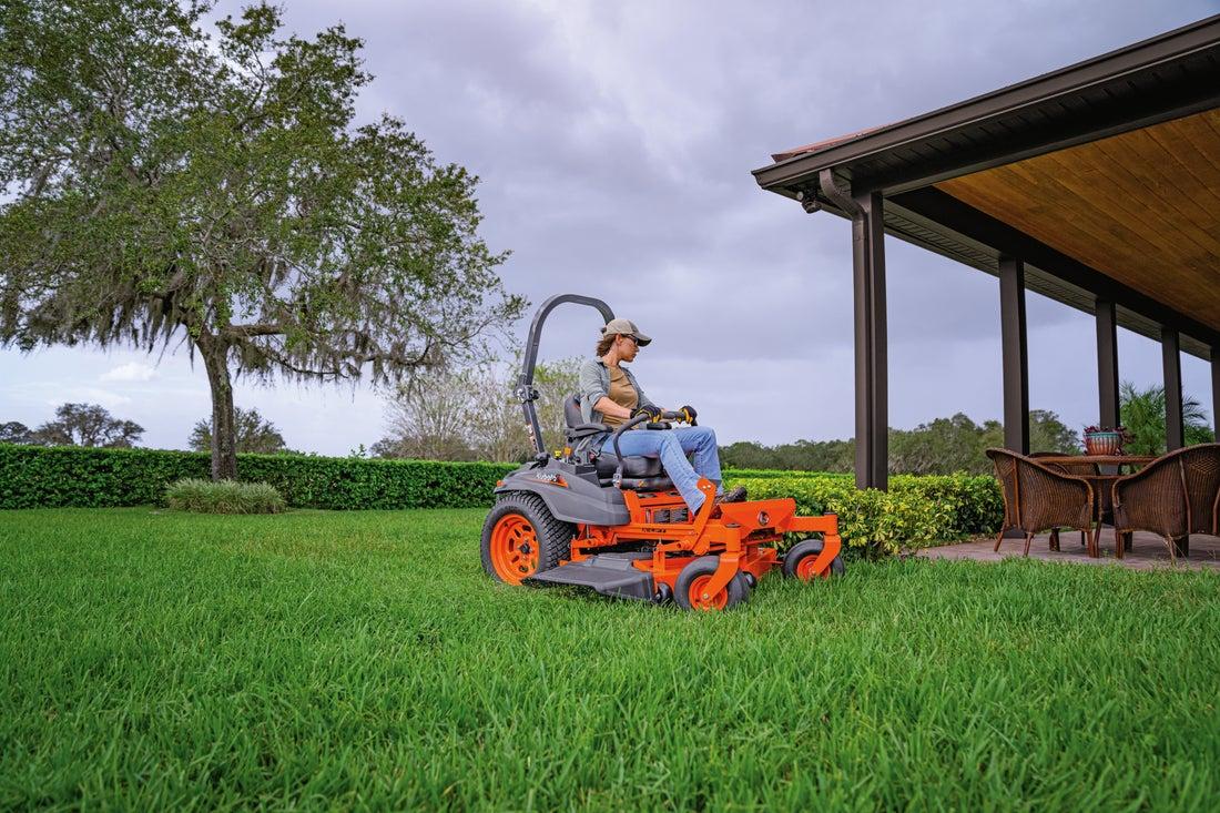 Woman mowing lawn with Kubota Zero- Turn mower