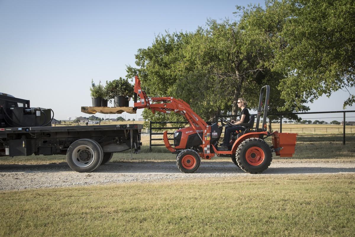 Tractor loading the back of truck