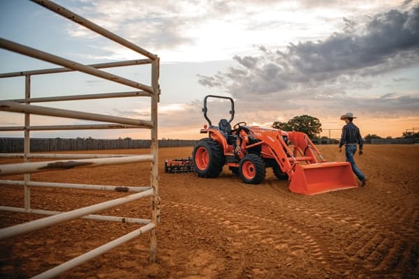 Man walking up towards tractor