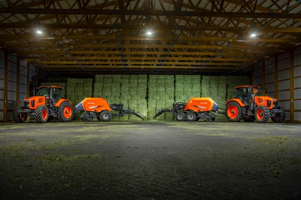 Kubota tractor and baler in shed of fresh hay